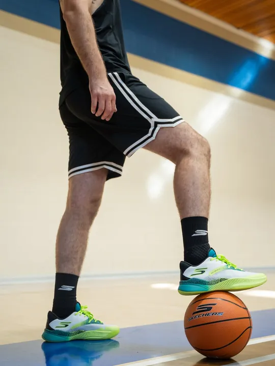 Danilo's Skechers SKX Nexus shoes, one foot on a Skechers ball
