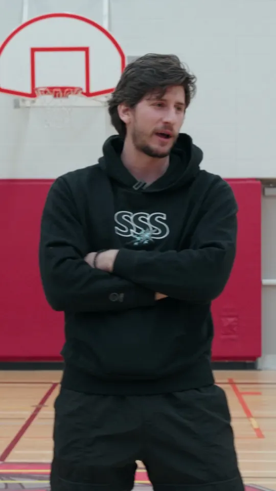 Danilo talking with young players in a school gym